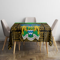 Rectangular tablecloth with black and gold geometric motifs, green trim, central emblem