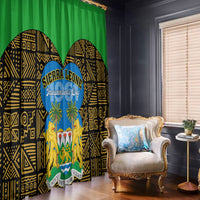 Green window curtain panels with black-gold geometric print and blue Sierra Leone Independence Day oval logo