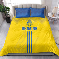 Yellow duvet cover with UKRAINE text, blue geometric pattern, and two blue pillowcases