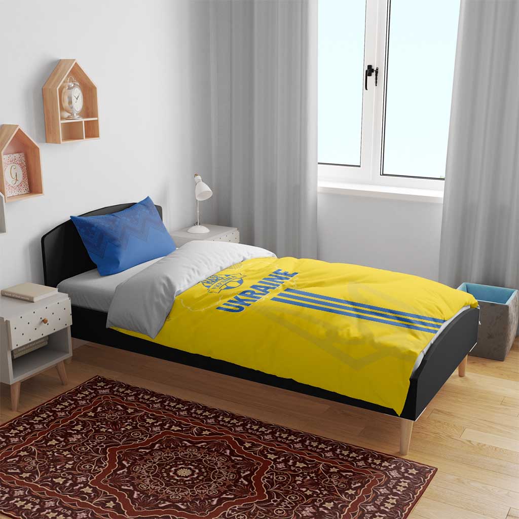 Yellow duvet with UKRAINE text and blue stripes, with two blue pillowcases