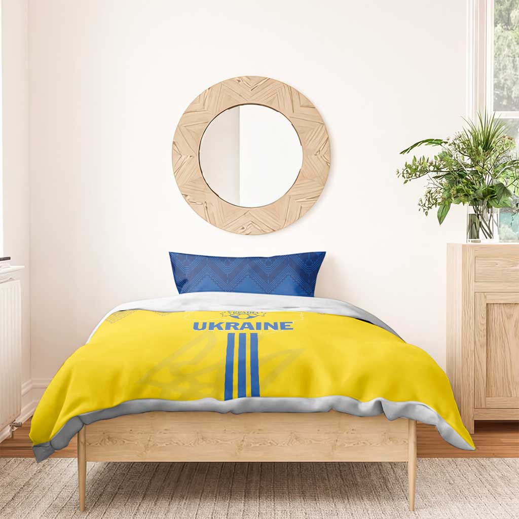 Yellow duvet cover with UKRAINE text and blue vertical stripes, plus two blue pillowcases
