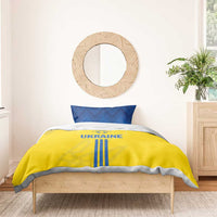 Yellow duvet cover with UKRAINE text and blue vertical stripes, plus two blue pillowcases
