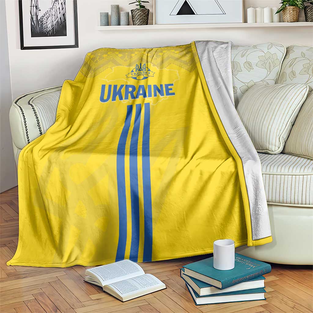 Yellow football blanket with Ukraine emblem and blue stripes, folk pattern on top