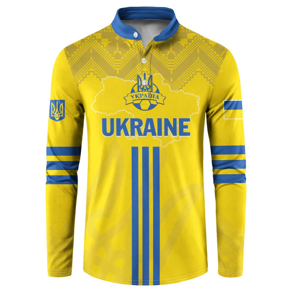 Yellow football button sweatshirt with blue folk pattern, crest, and long sleeves.