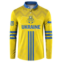 Yellow football button sweatshirt with blue folk pattern, crest, and long sleeves.