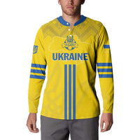 Yellow football button sweatshirt on model, with blue Ukraine crest and vertical stripes.
