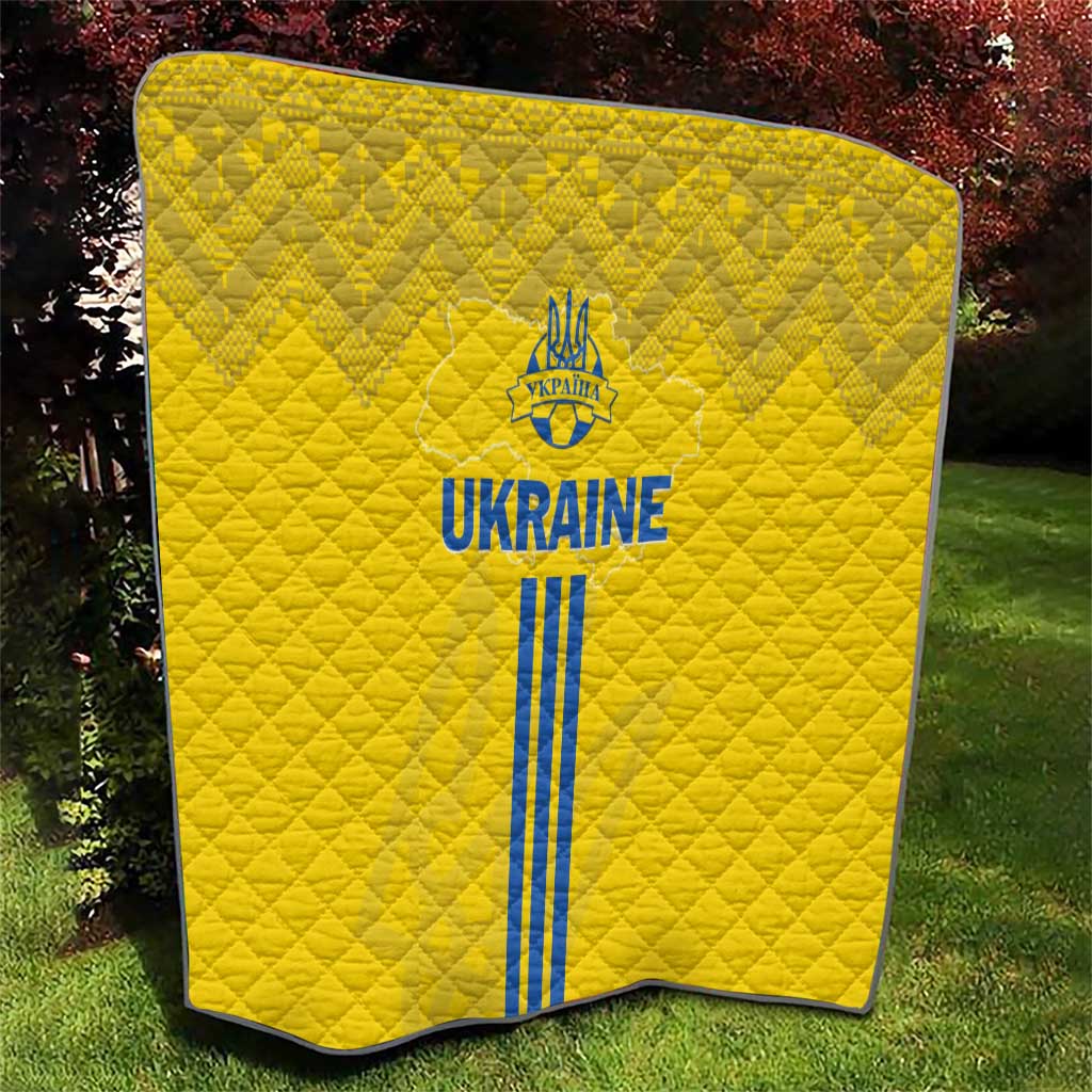 Yellow quilt with quilted diamond pattern and blue Ukraine emblem, text, and stripes