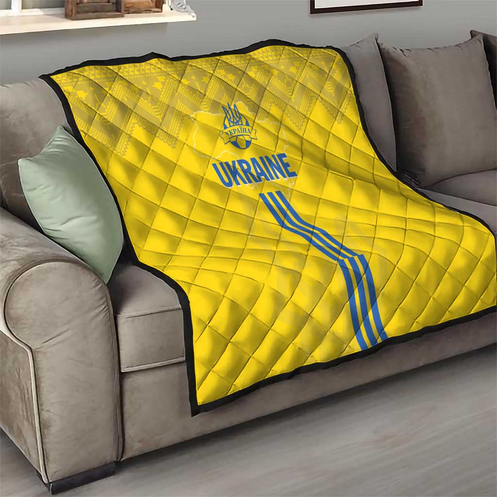 Yellow quilt on a living-room sofa with blue Ukraine text and vertical stripe graphic