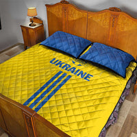 Yellow quilt bed set with blue Ukraine text and diagonal stripe, with two blue pillows