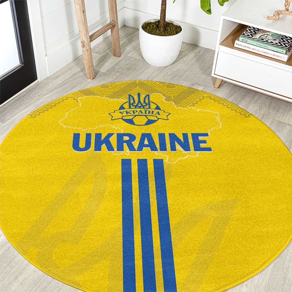 Yellow round carpet with UKRAINE text, gold trident emblem, and blue flag stripes