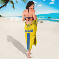 Yellow Ukraine football sarong with folk pattern, blue stripes and 'Ukraine' logo, tied