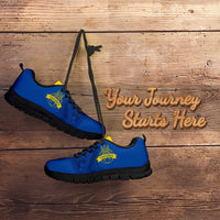 Blue football sneakers with yellow accents, lace-up design, and black tread sole