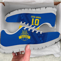 Blue football sneakers with Ukrainian emblem, yellow laces, and white tread sole