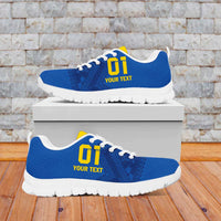 Blue football sneakers with yellow logo and black laces, white tread sole