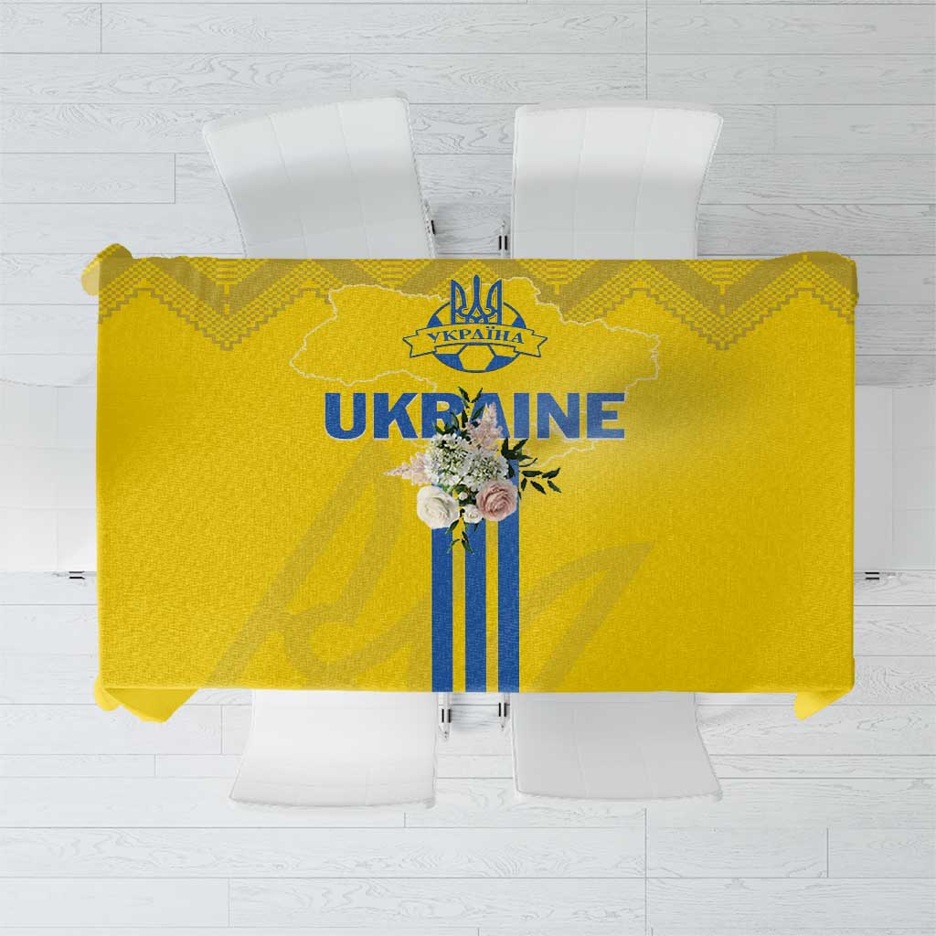 Yellow tablecloth with blue trident-style stripes and folk border pattern