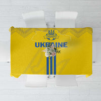 Yellow tablecloth with blue trident-style stripes and folk border pattern