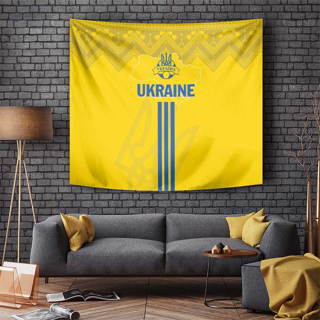 Yellow rectangular tapestry with 'UKRAINE' text, blue trident logo, and vertical stripes