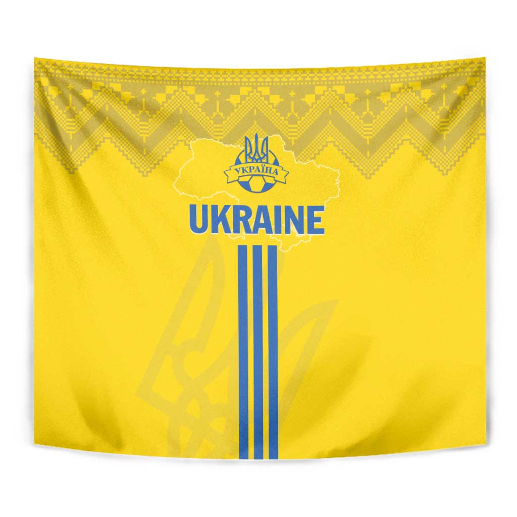 Yellow Ukraine tapestry close-up with blue 'UKRAINE' text, trident crest, and striped emblem