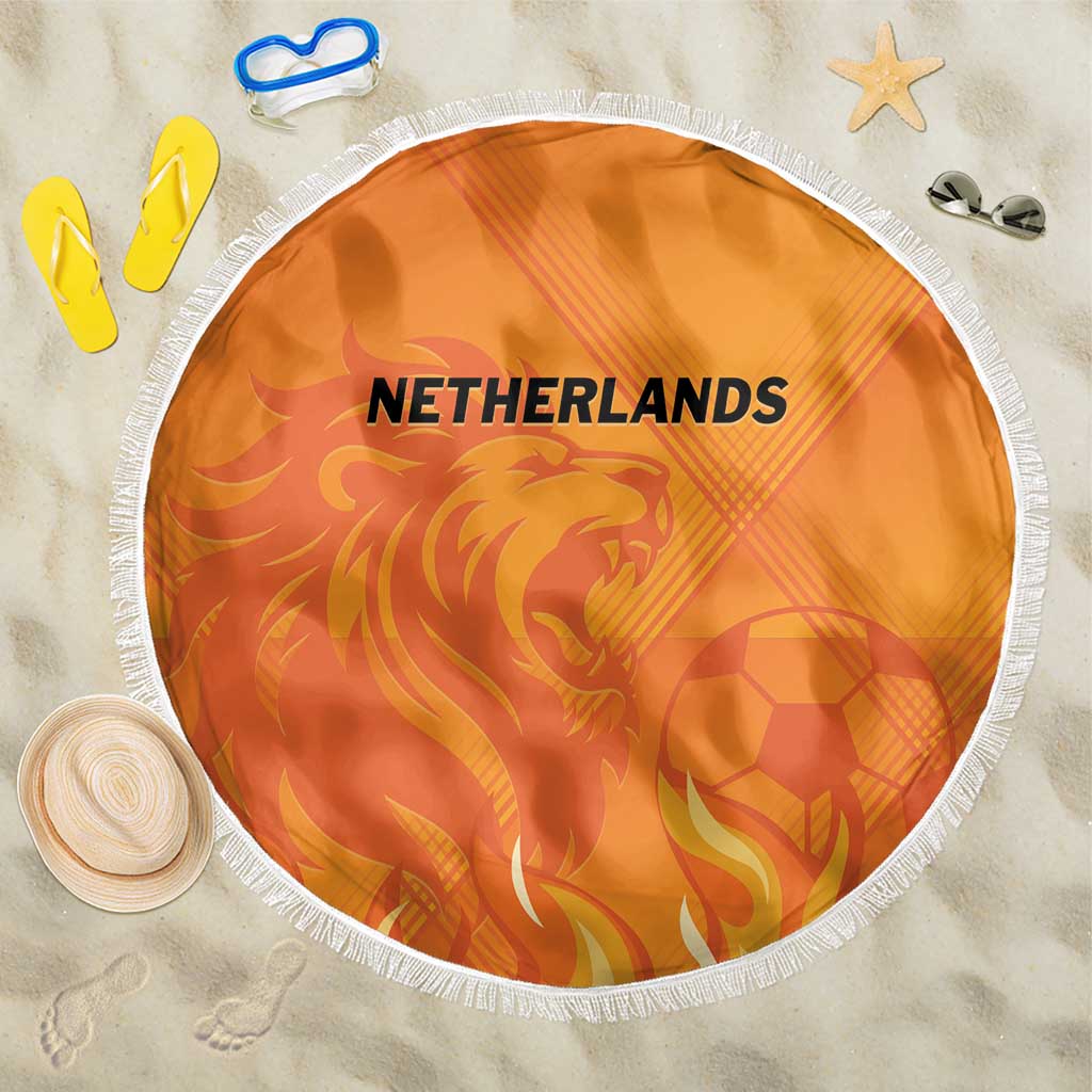 Round orange Netherlands football beach blanket with lion graphic and white fringe