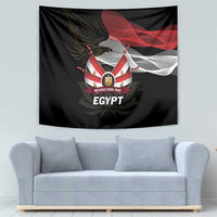 Black wall tapestry with eagle and lotus design plus “Revolution Day Egypt” lettering