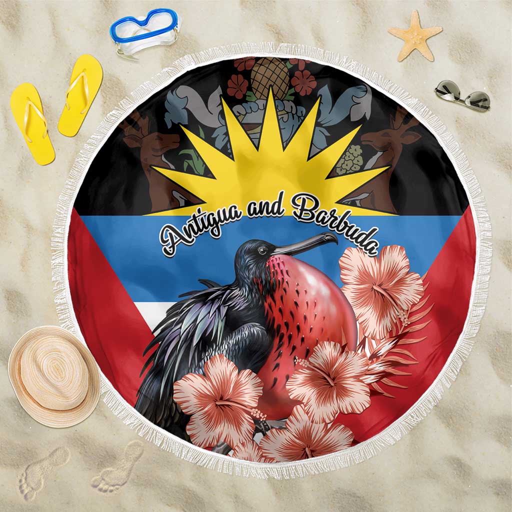 Round beach blanket with white fringe, frigatebird and hibiscus over Antigua flag