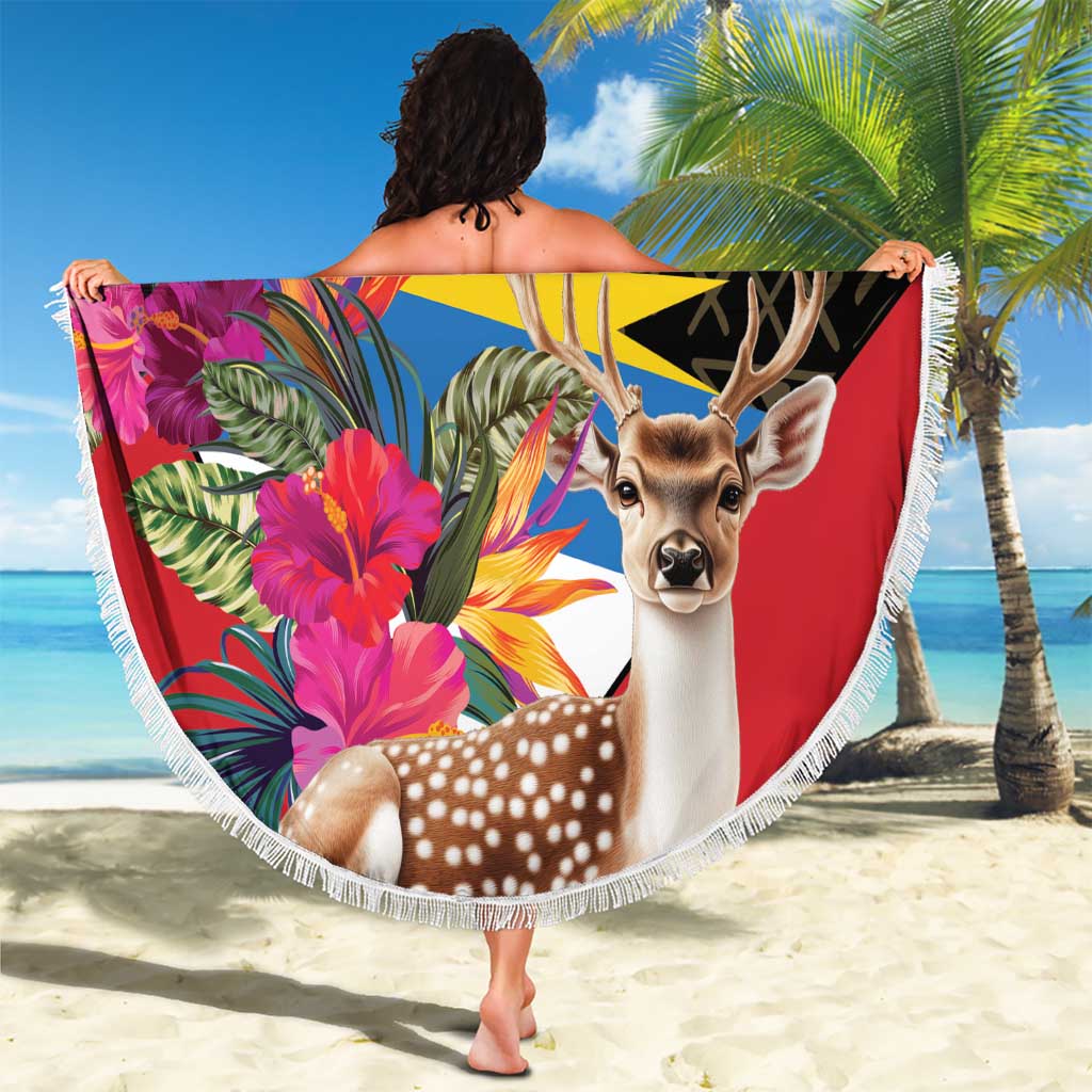Fringed round beach blanket with deer head artwork, colorful tropical blooms, Antigua and Barbuda logo