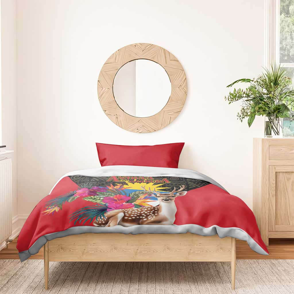 Red duvet with deer and tropical floral print on dark geometric panel, with red pillows