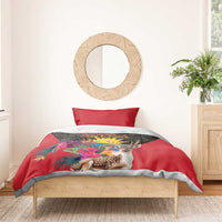 Red duvet with deer and tropical floral print on dark geometric panel, with red pillows