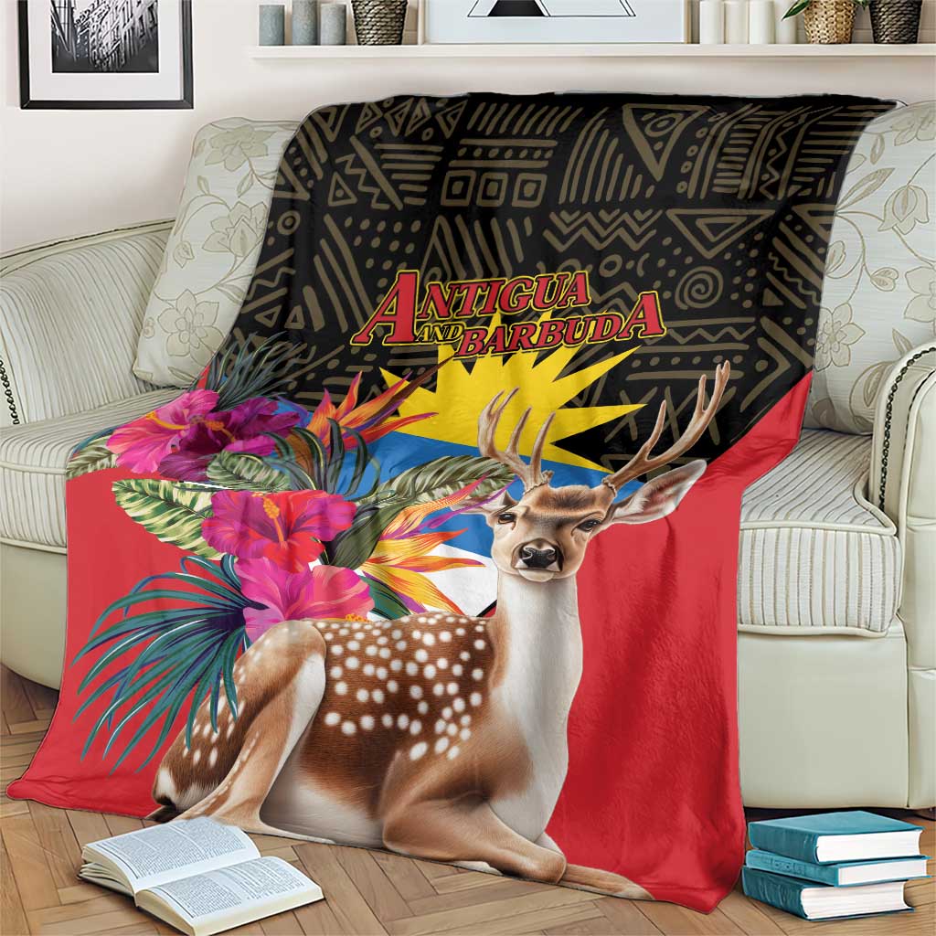 Antigua and Barbuda tropical deer print blanket on beige sofa, red with deer and jungle flowers