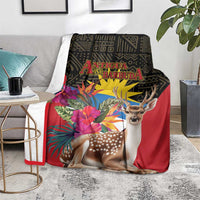 Antigua and Barbuda tropical deer print blanket on living room sofa, red with colorful tropical blooms