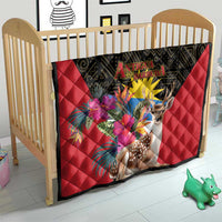 Red quilt blanket with black border, deer and tropical flowers on a baby bed