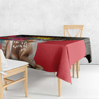 Red tablecloth with deer imagery and black patterned edge on dining table