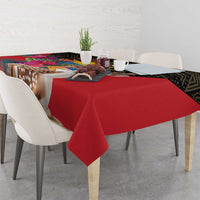 Red tablecloth draped over dining table edge with deer and floral print