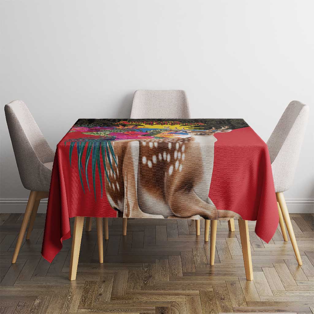 Red tablecloth on square dining table with deer portrait and colorful tropical band