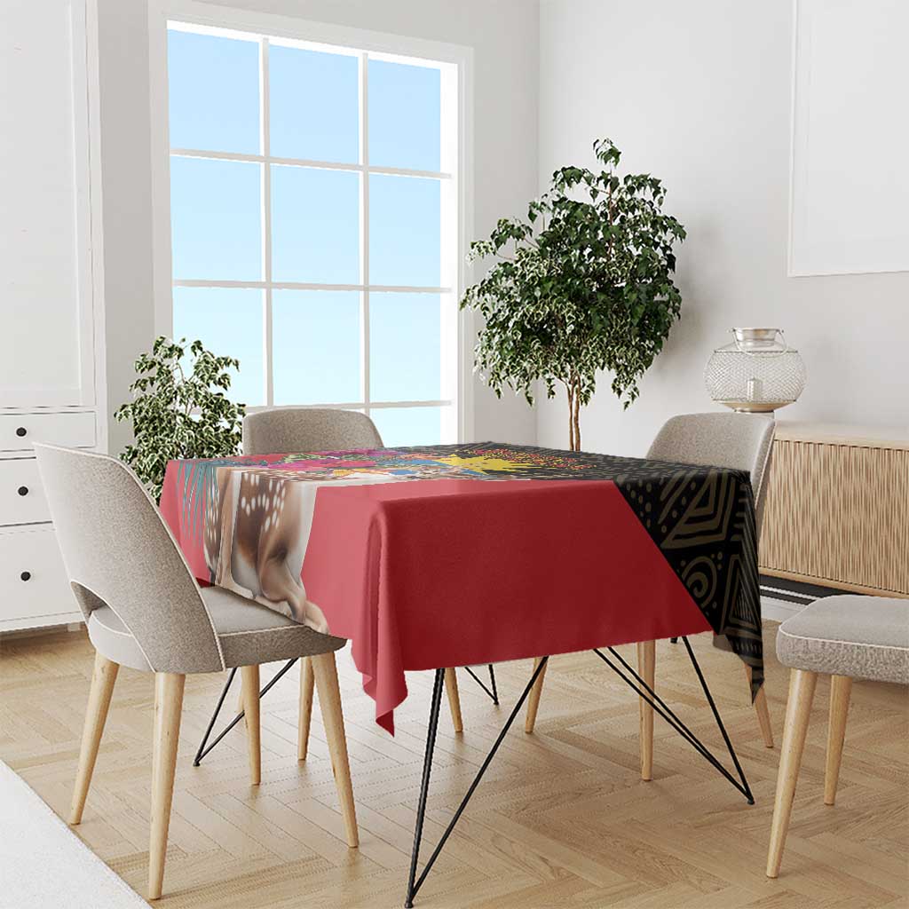Red tablecloth on dining table with deer and tropical bouquet design across top