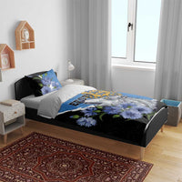 Blue and black bedding set with wolf and blue flowers on a bed with two pillowcases