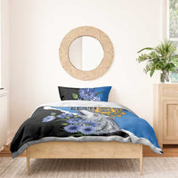 Blue and black bedding set with wolf face and blue flowers, on a wooden bed frame