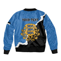 Blue bomber jacket with black back panel, "YOUR TEXT" and Estonia crest graphic, ribbed hem