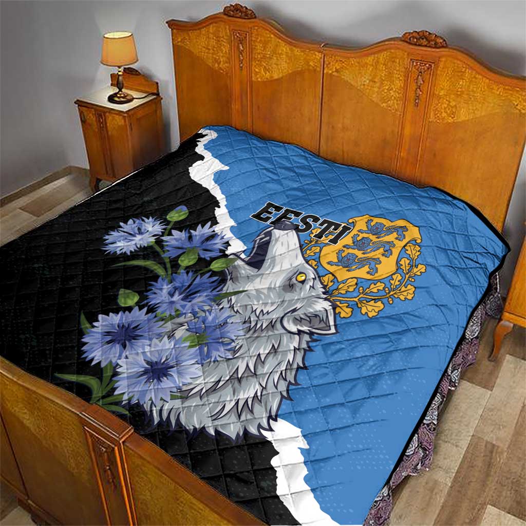 Quilt on bed: blue and black with diagonal white stripe, wolf and flower print, gold crest