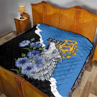 Quilt on bed: blue and black with diagonal white stripe, wolf and flower print, gold crest