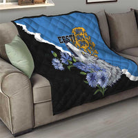 Blue and black quilt on sofa: diagonal white stripe with wolf face, flowers, gold crest