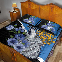 Blue quilt bed set with wolf print, blue flowers, and black accents on two pillows
