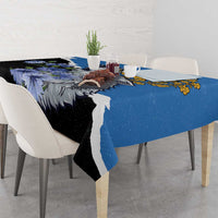 Blue tablecloth featuring wolf head and wildflowers across tabletop