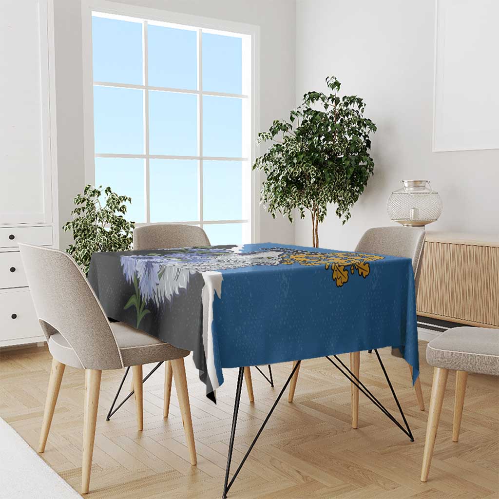 Blue tablecloth with wolf and wildflower design, laid over a dining table