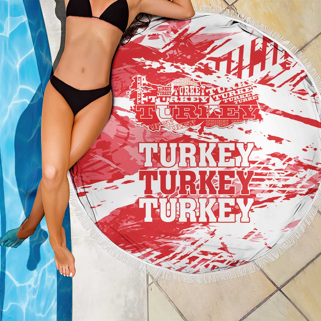 Round beach blanket draped on swimmer, red-and-white Turkey graphic, fringed edge