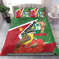 Green, red, and white Suriname bedding set with bird print and two decorative pillowcases