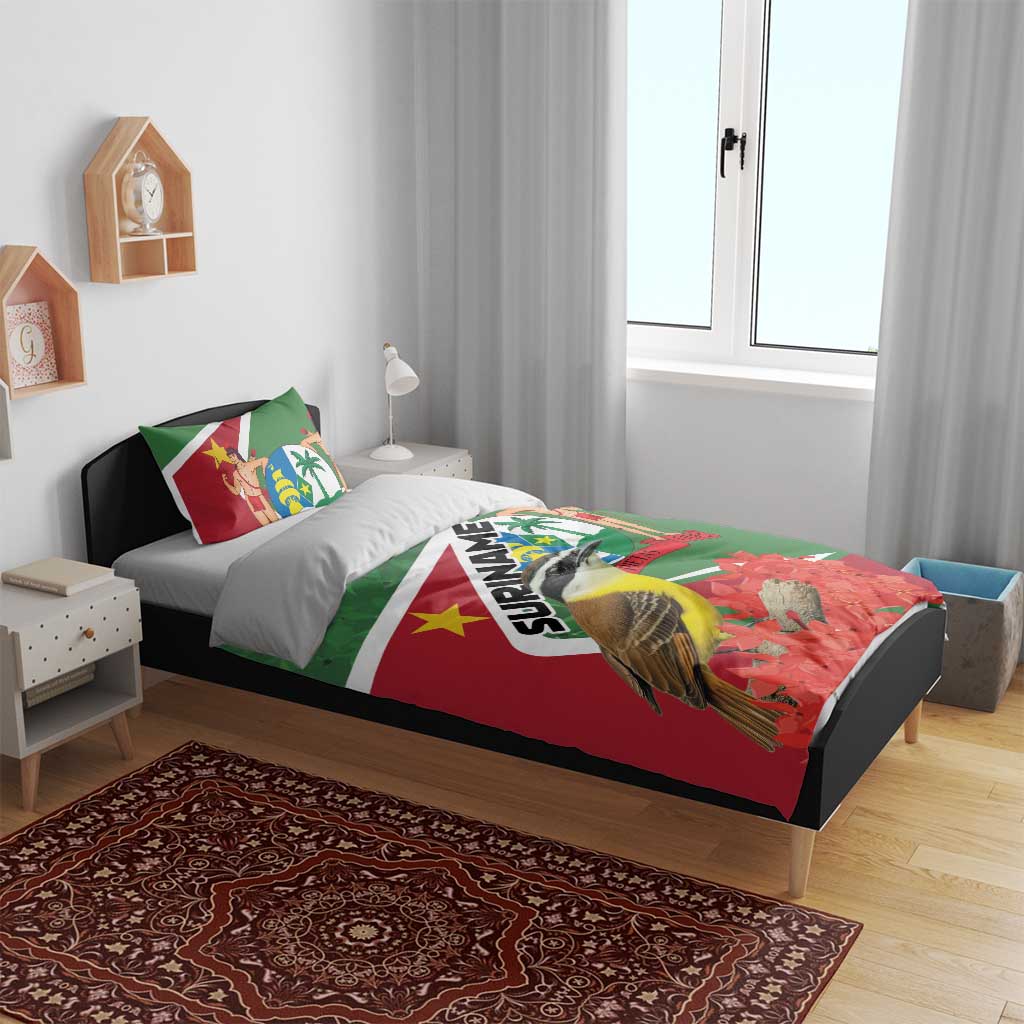 Suriname-themed bedding set on bed: green/red duvet with bird artwork and two pillows
