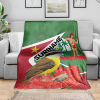 Suriname-themed blanket with green-and-red flag print, bird, woman, palm and flowers