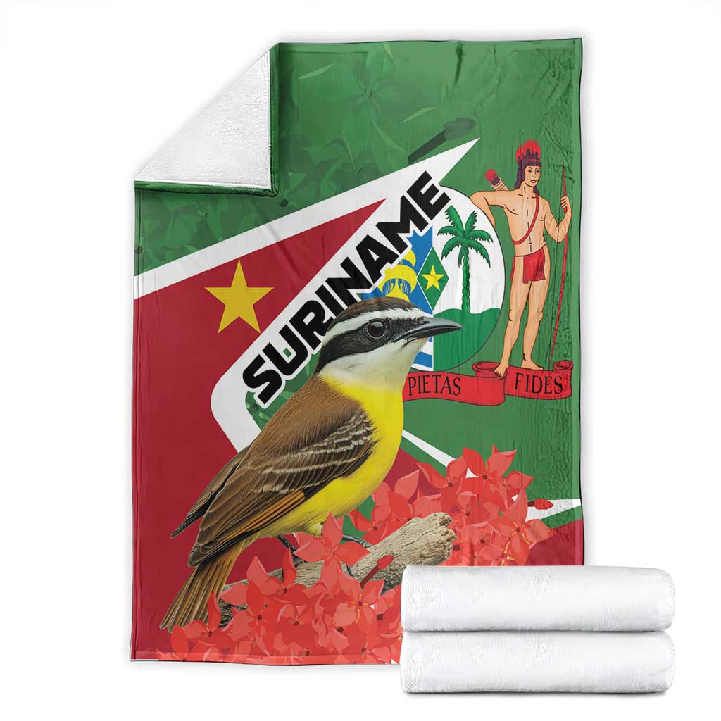 Suriname-themed blanket folded, green-and-red flag print with bird, palm and flowers