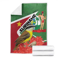 Suriname-themed blanket folded, green-and-red flag print with bird, palm and flowers